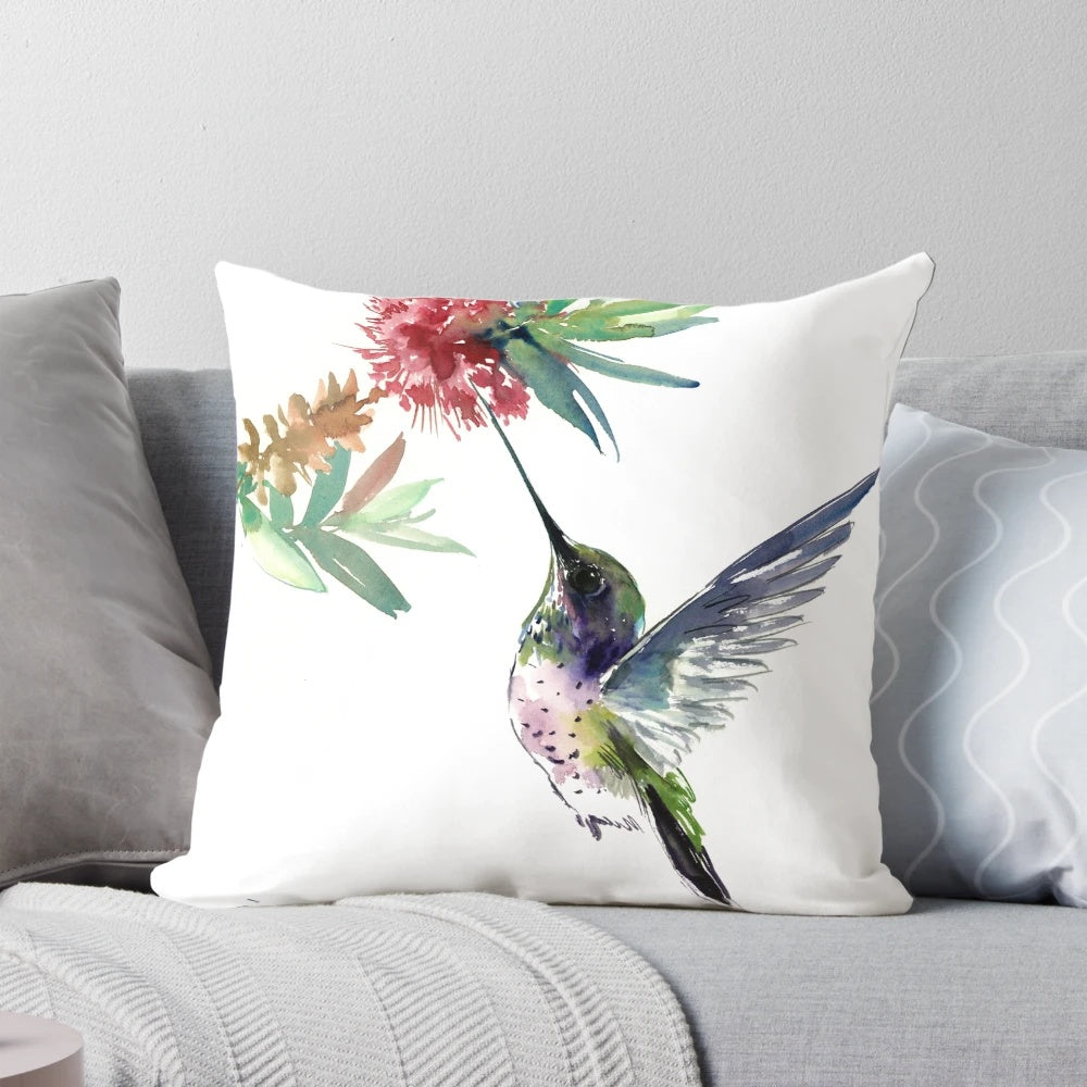 Vibrant hummingbird and flower design on a soft, decorative pillow