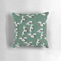A beautiful throw pillow featuring a repeating Japanese crane pattern in shades of blue, teal, and white.