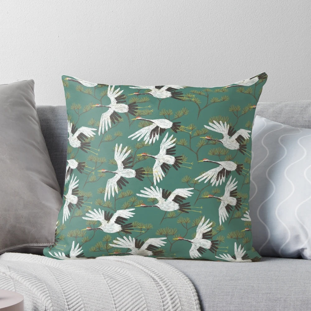 A beautiful throw pillow featuring a repeating Japanese crane pattern in shades of blue, teal, and white.