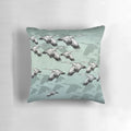 Decorative Japanese-inspired throw pillow featuring a pattern of graceful flying cranes in shades of green and earthy tones.