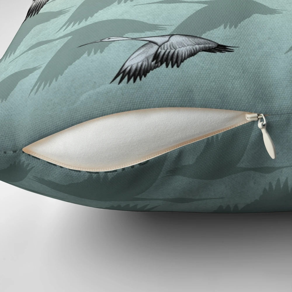 Decorative Japanese-inspired throw pillow featuring a pattern of graceful flying cranes in shades of green and earthy tones.