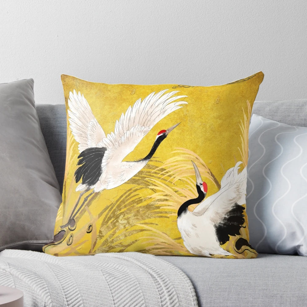 Closeup image of a traditional oriental pillow featuring a seamless pattern of golden Japanese cranes on a black background.