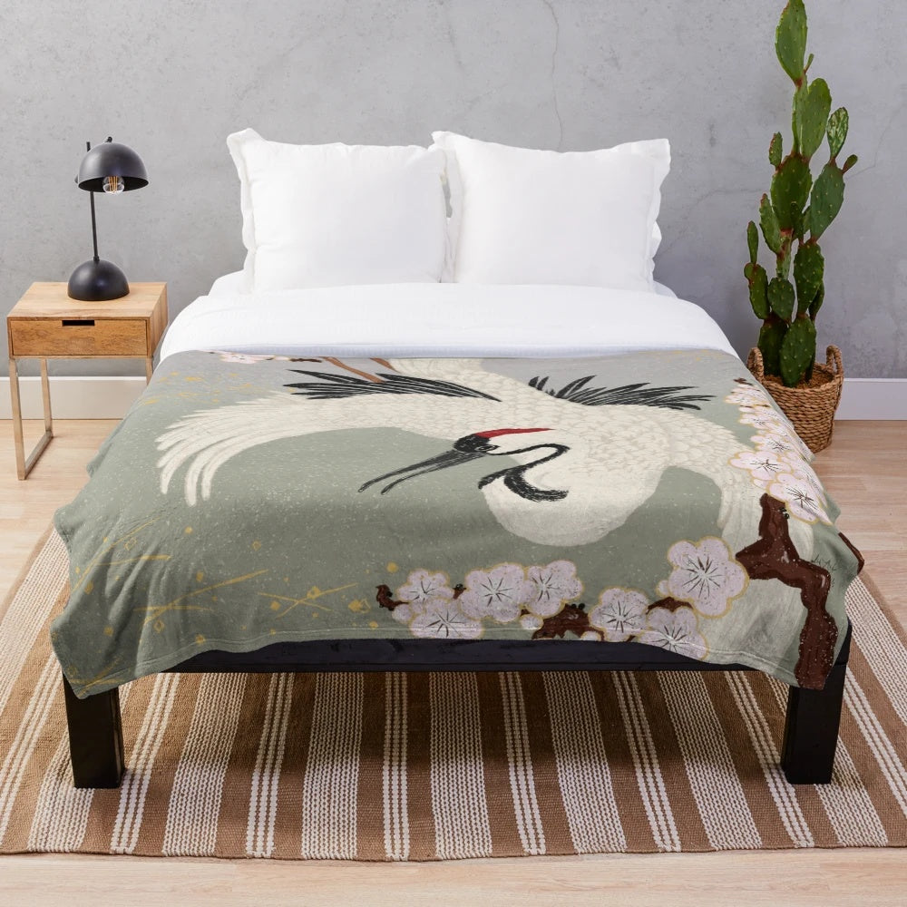 Japanese crane plush blanket in pink, green, and black with sakura blossoms
