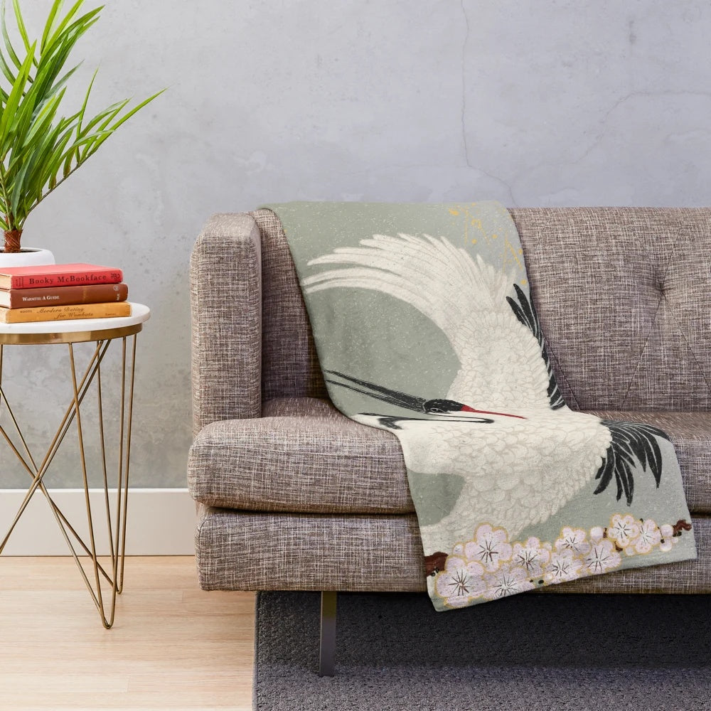 Japanese crane plush blanket in pink, green, and black with sakura blossoms