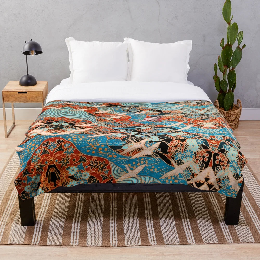Plush blanket featuring white cranes flying over blue waters and spring flowers
