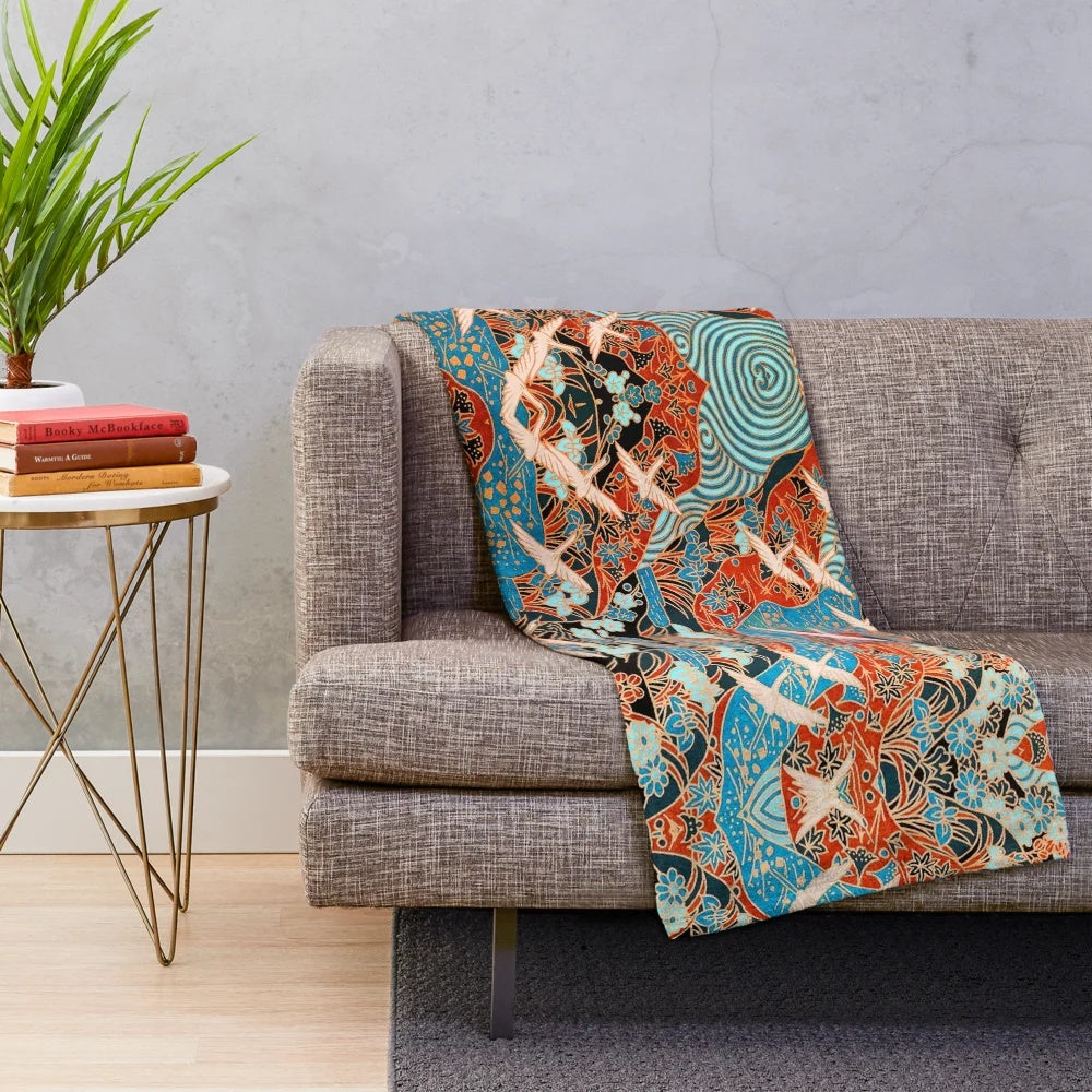 Plush blanket featuring white cranes flying over blue waters and spring flowers