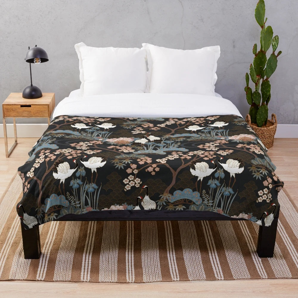 Japanese garden-inspired dark plush blanket with delicate white cranes and cherry blossoms