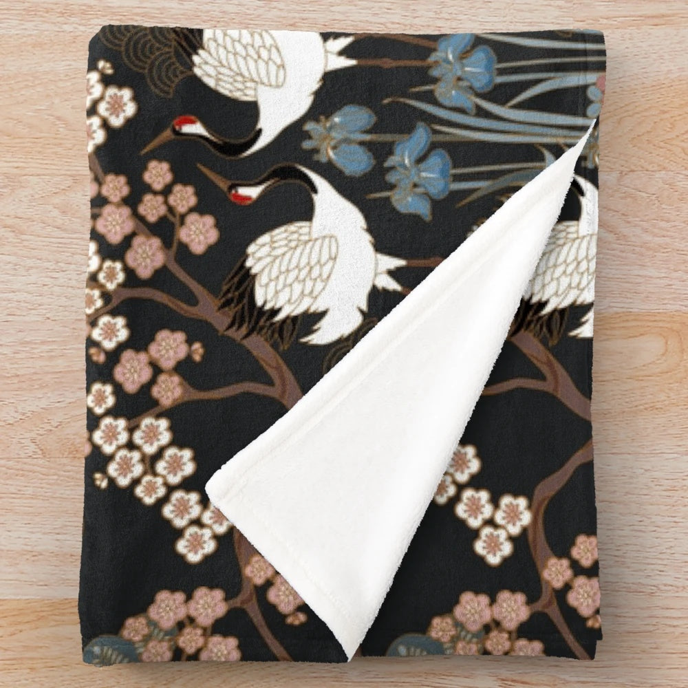 Japanese garden-inspired dark plush blanket with delicate white cranes and cherry blossoms