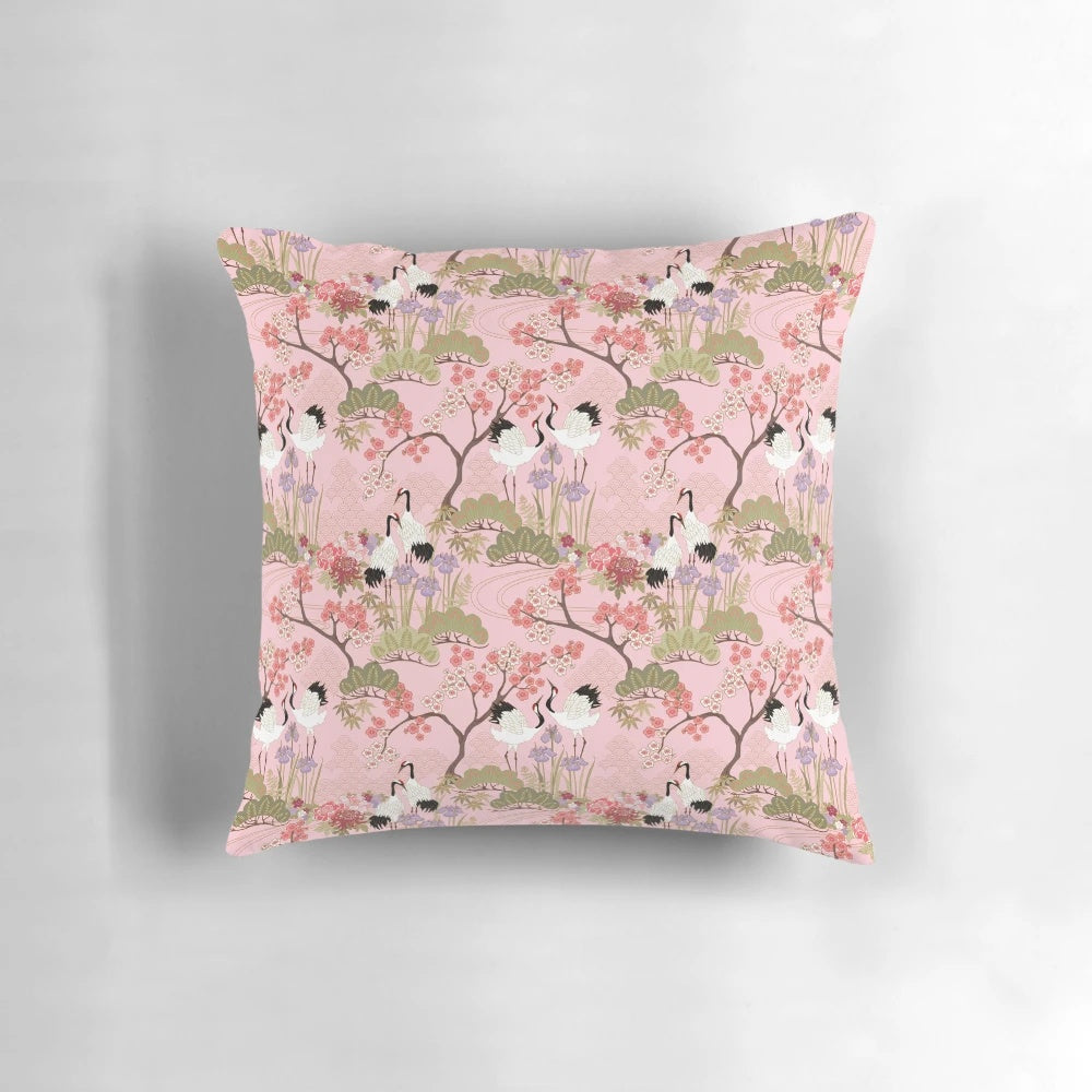 Vibrant pink and white floral pillow with Japanese garden and crane motifs.