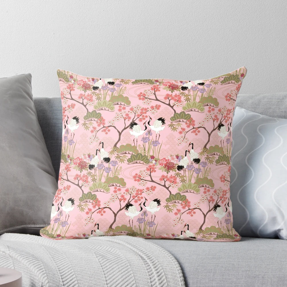 Vibrant pink and white floral pillow with Japanese garden and crane motifs.