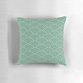 Decorative green pillow with a repeating fan pattern, inspired by Japanese design and featuring a fish scale-like motif.