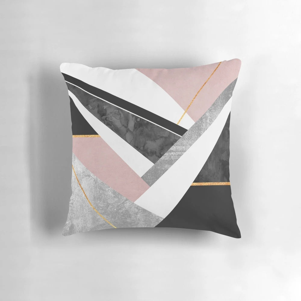 Soft pink and gold pillow with abstract geometric patterns