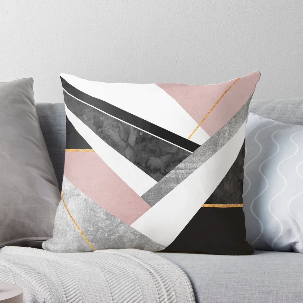 Soft pink and gold pillow with abstract geometric patterns