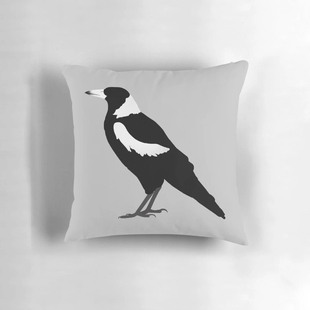 Magpie decorative pillow with black and white feathers in a profile side view