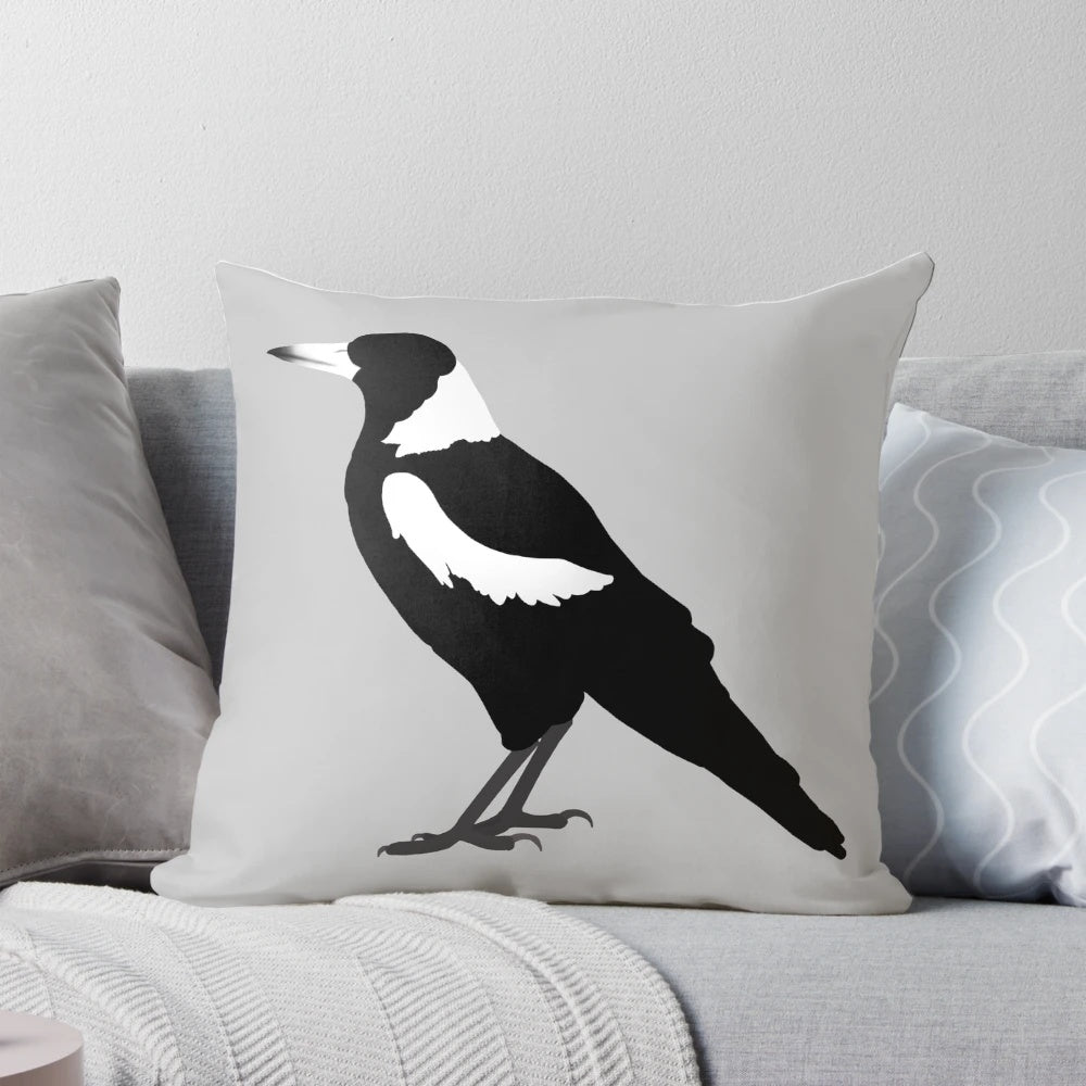 Magpie decorative pillow with black and white feathers in a profile side view