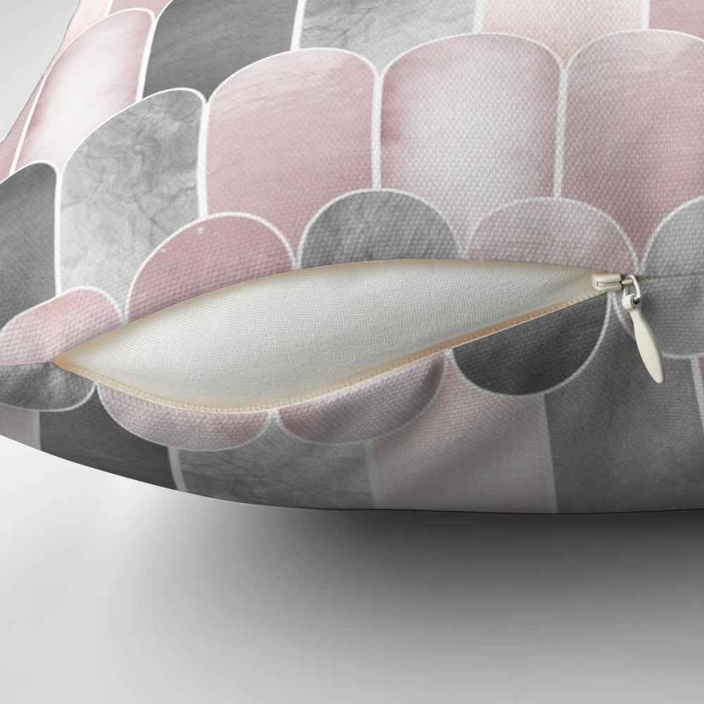 A minimalist mid century-inspired pillow featuring a pattern of overlapping arches in blush pink and grey.
