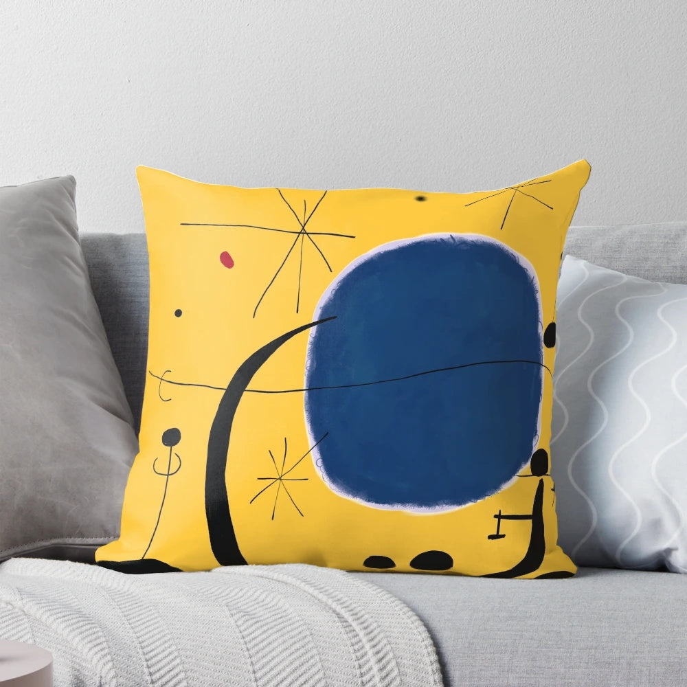 Striking pillow featuring a minimalist abstract design in bold blue and yellow tones, inspired by the iconic artwork of Joan Miró.