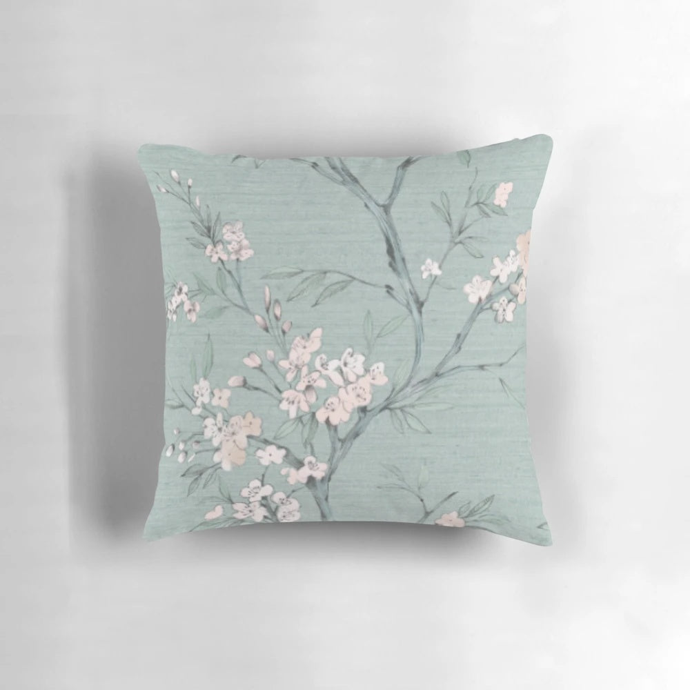 A modern, nature-inspired pillow with a minimalist, geometric design in duck egg blue and cream colors.