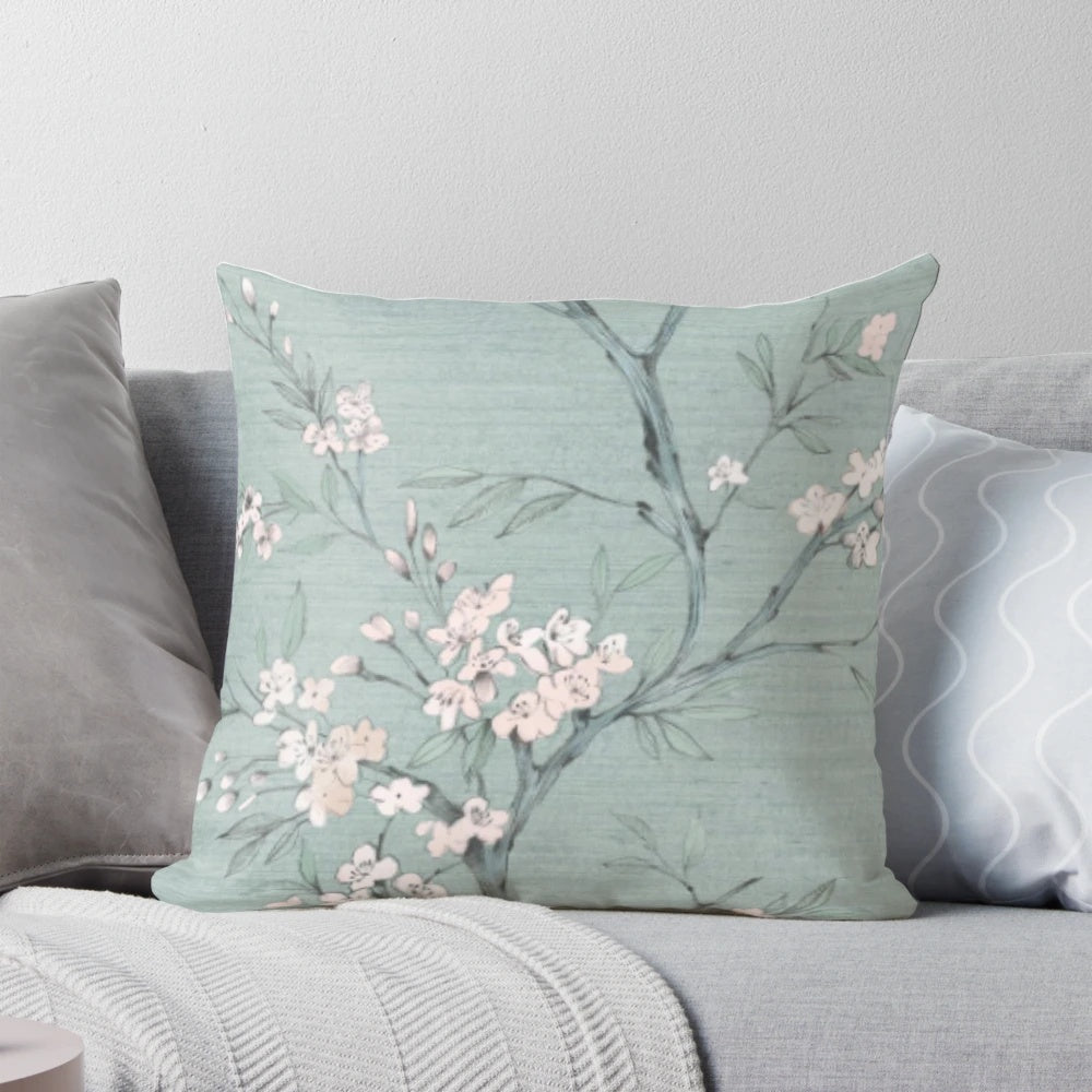 A modern, nature-inspired pillow with a minimalist, geometric design in duck egg blue and cream colors.
