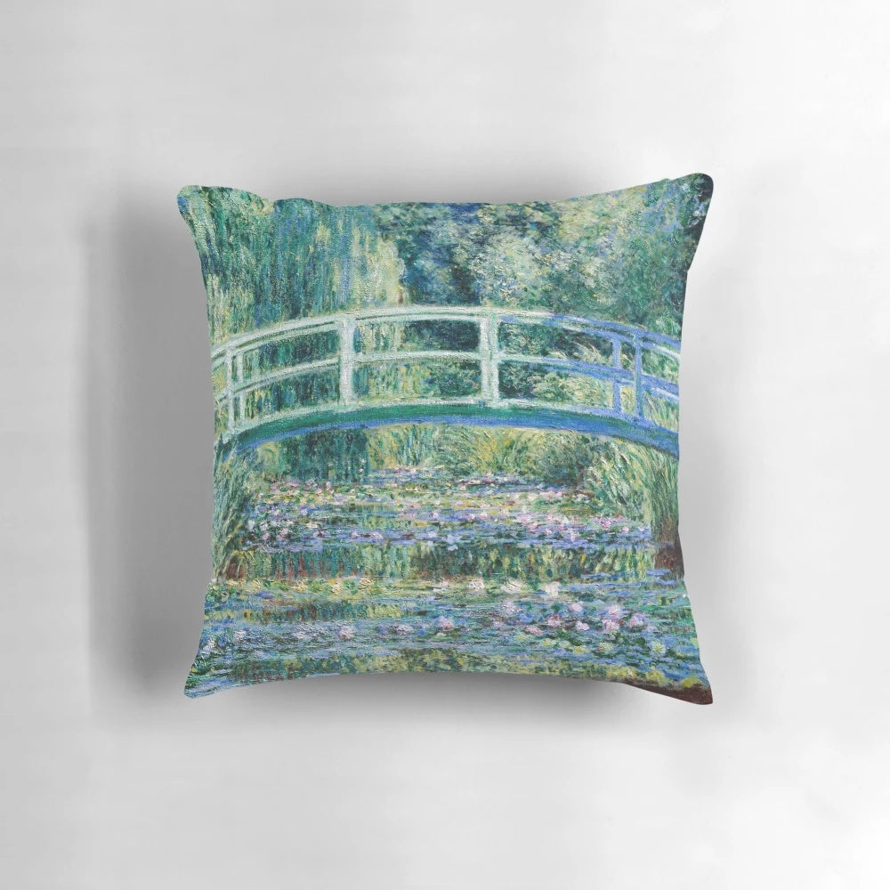 A vibrant throw pillow featuring Claude Monet's famous water lilies and Japanese bridge painting.