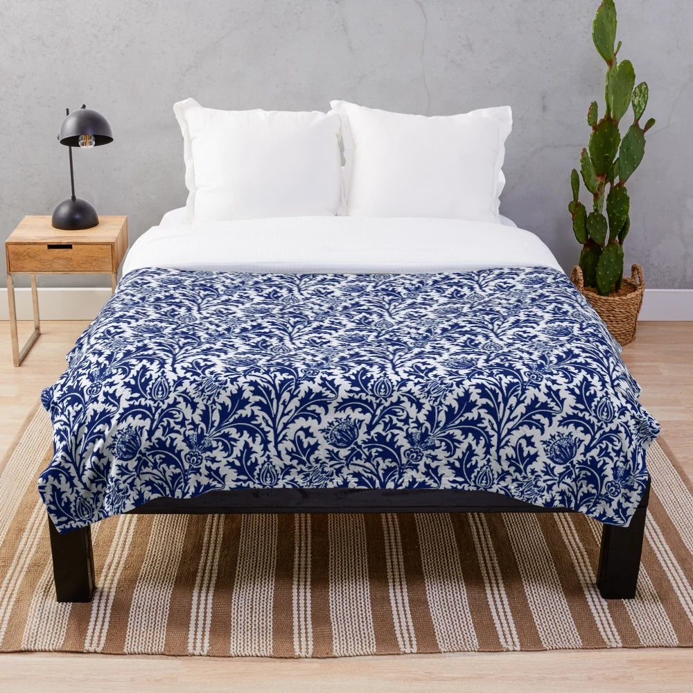 Vintage-inspired navy blue and white plush blanket featuring a damask thistle floral design in the William Morris art nouveau style.