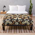 Navy blue, cream, and orange floral plush blanket with botanical garden inspired pattern