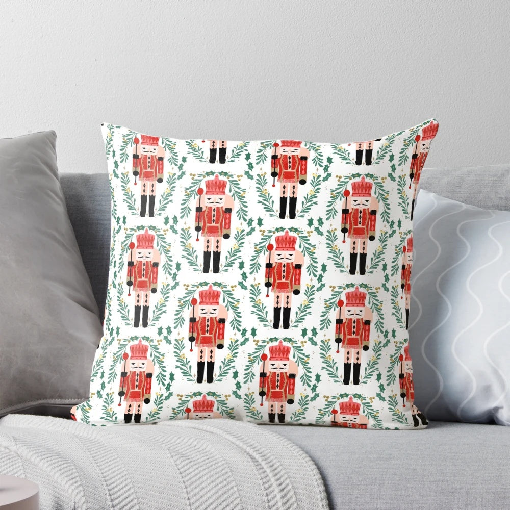 A vibrant red and green pillow featuring the iconic Nutcracker ballet design by artist Andrea Lauren.