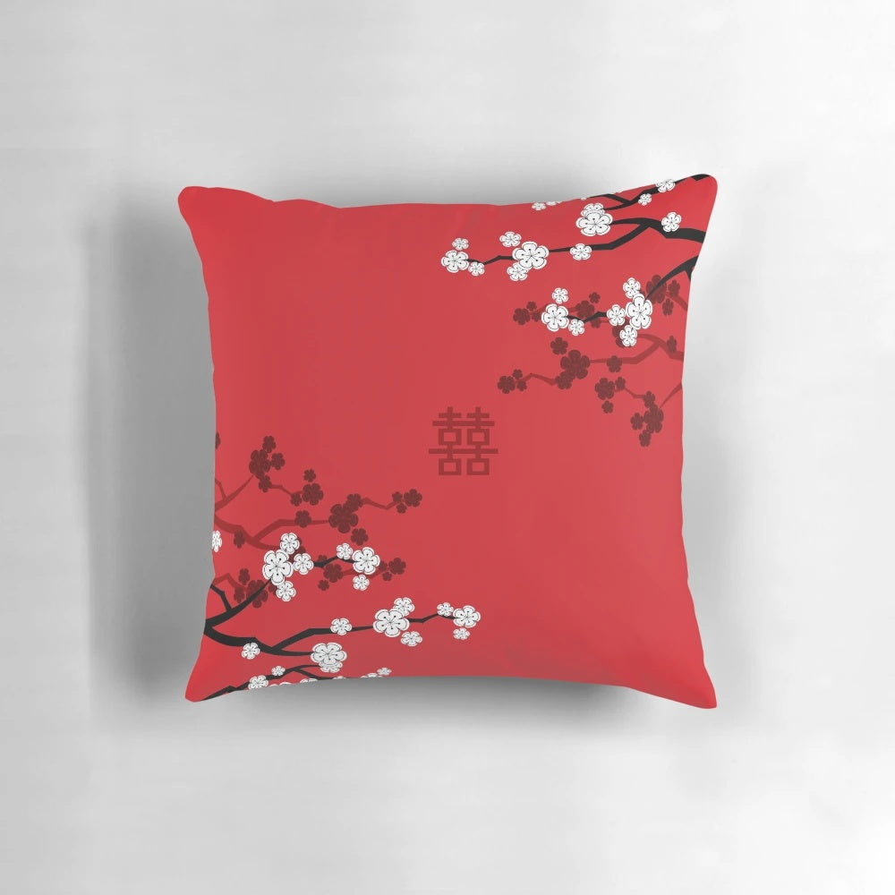 Decorative pillow showcasing vibrant Japanese Sakura cherry blossoms against a red background