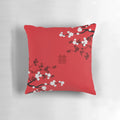 Decorative pillow showcasing vibrant Japanese Sakura cherry blossoms against a red background