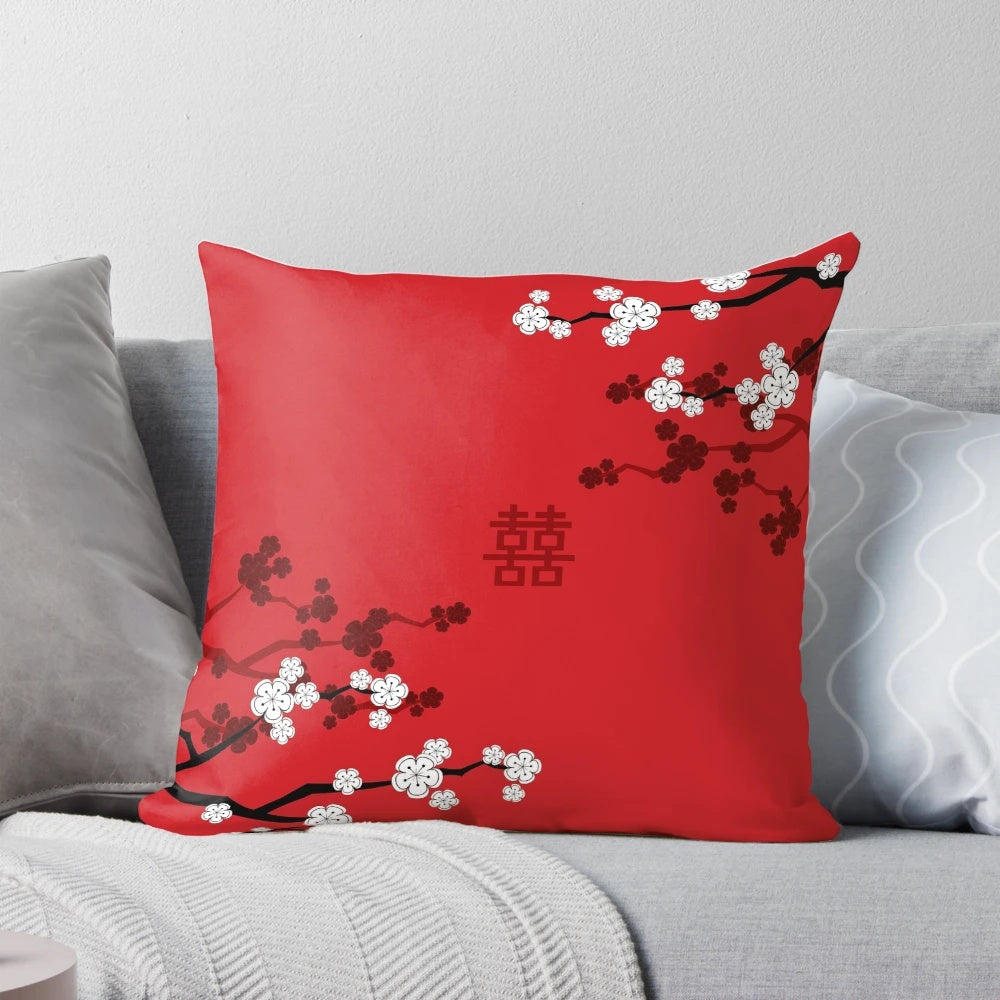 Decorative pillow showcasing vibrant Japanese Sakura cherry blossoms against a red background