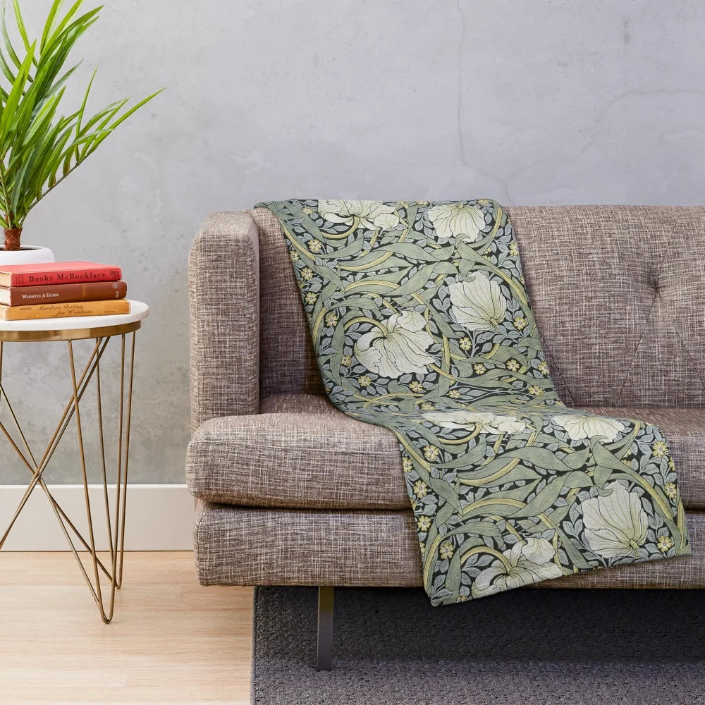 Pimpernel floral design plush blanket featuring green leaves, blue flowers, and gold accents