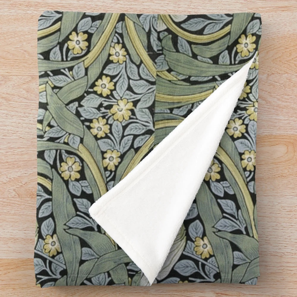 Pimpernel floral design plush blanket featuring green leaves, blue flowers, and gold accents