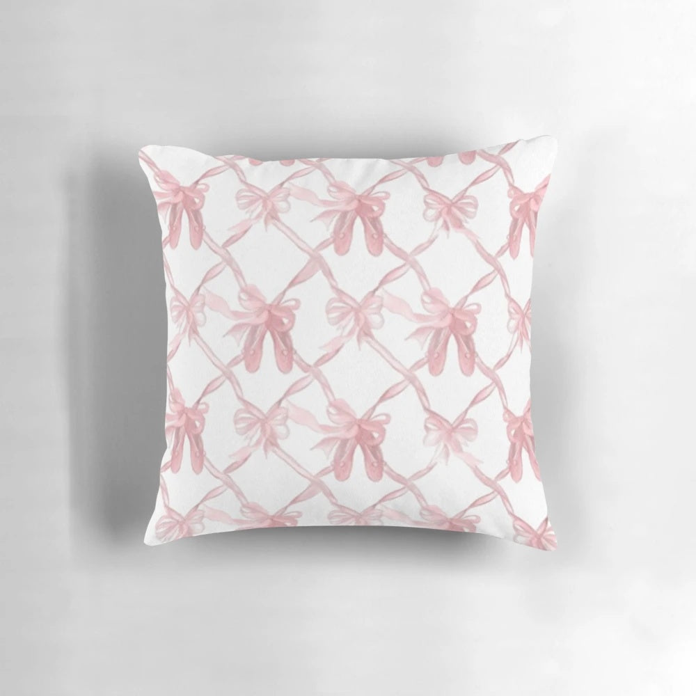 Soft, pink decorative pillow with delicate bows for a chic, ballerina-inspired style