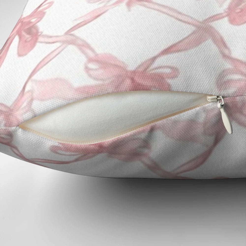 Soft, pink decorative pillow with delicate bows for a chic, ballerina-inspired style