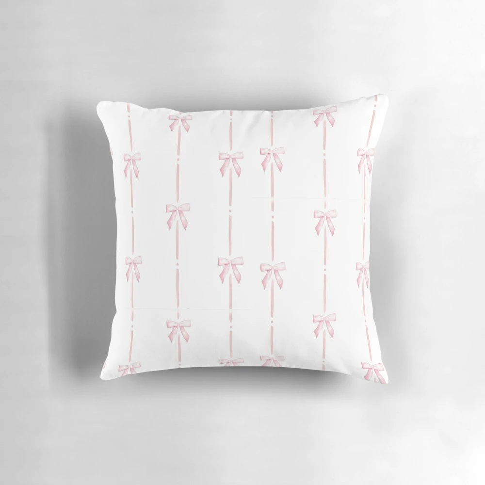 Soft and plush pink pillow with delicate bow ribbon detail, perfect for creating a cozy and stylish ambiance.