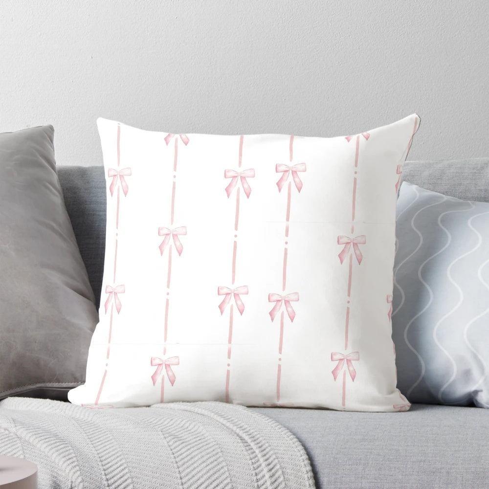 Soft and plush pink pillow with delicate bow ribbon detail, perfect for creating a cozy and stylish ambiance.