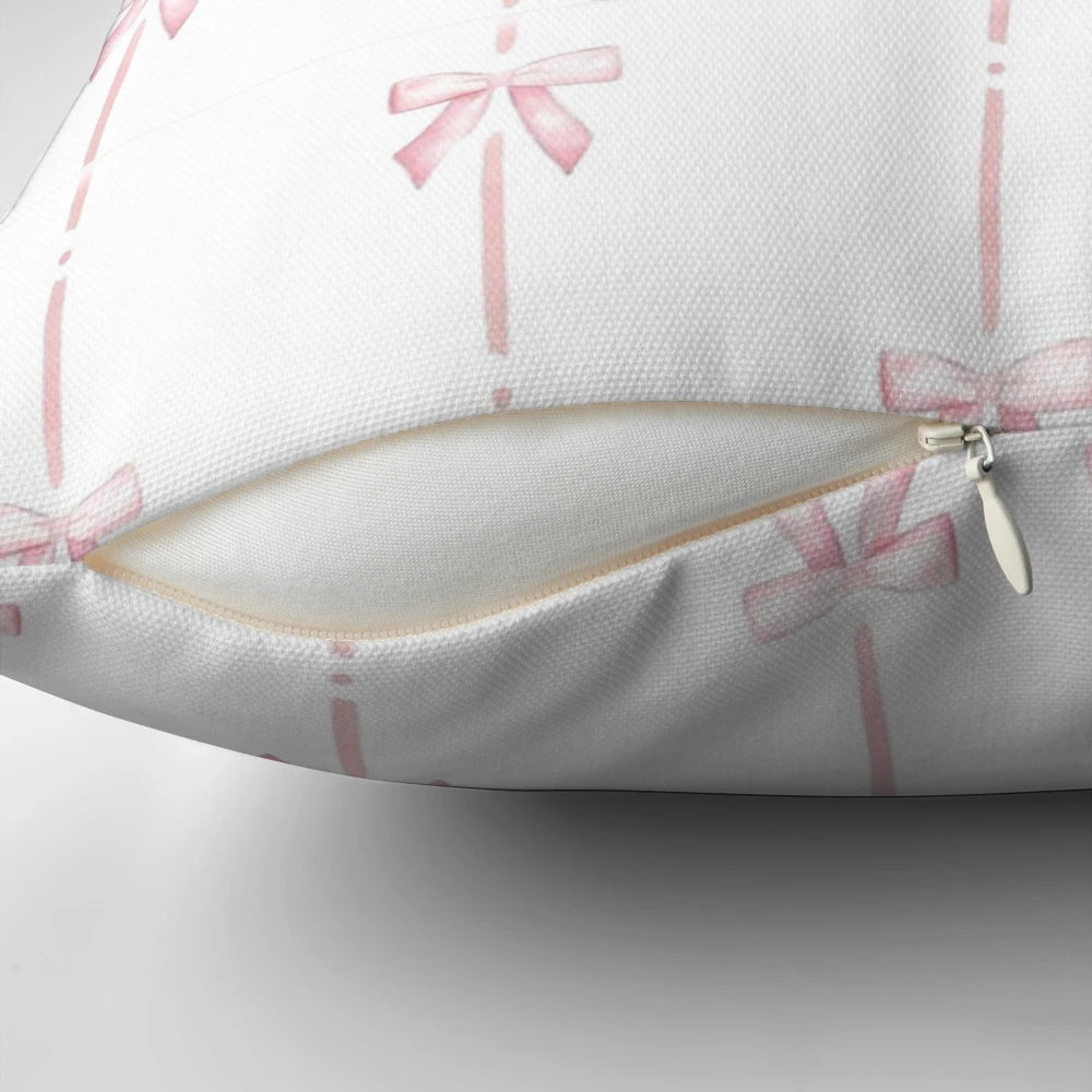 Soft and plush pink pillow with delicate bow ribbon detail, perfect for creating a cozy and stylish ambiance.