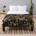 Plush blanket with intricate Polish folklore-inspired floral pattern in black and white