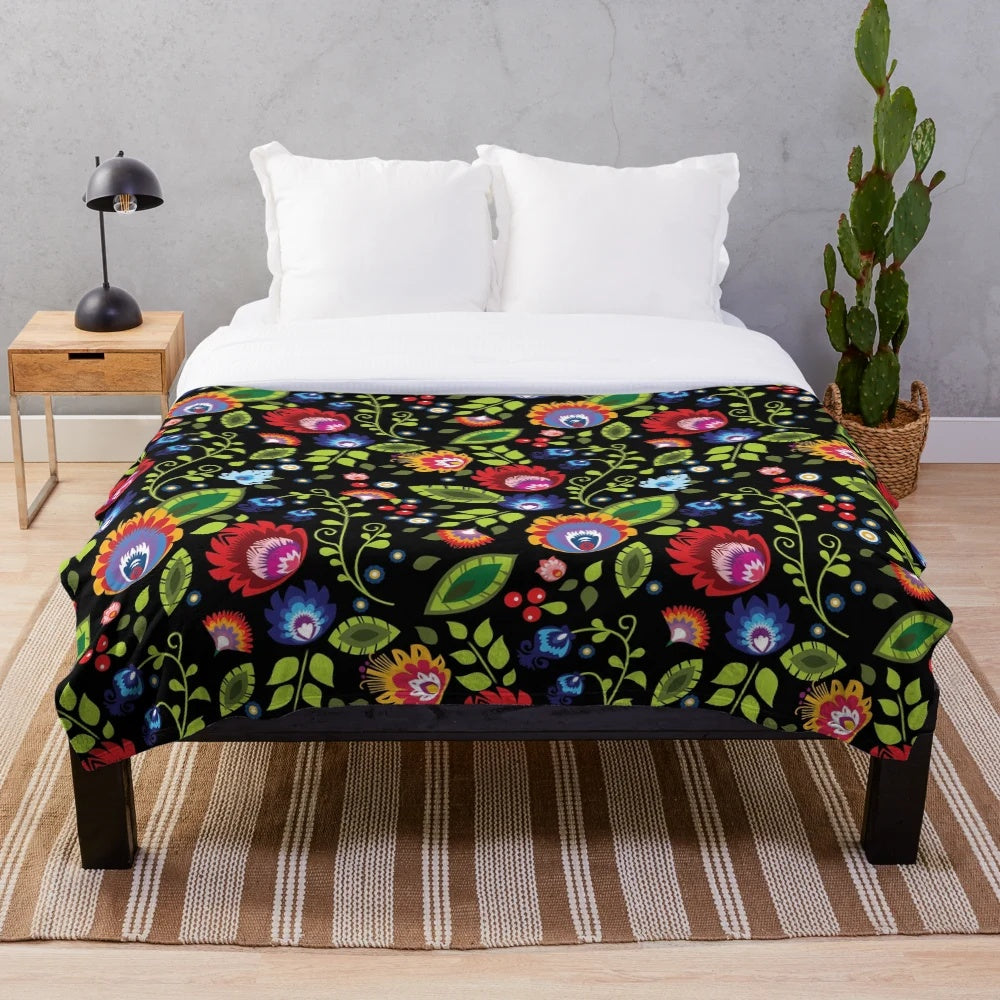 Plush blanket with intricate Polish folklore-inspired floral pattern in black and white