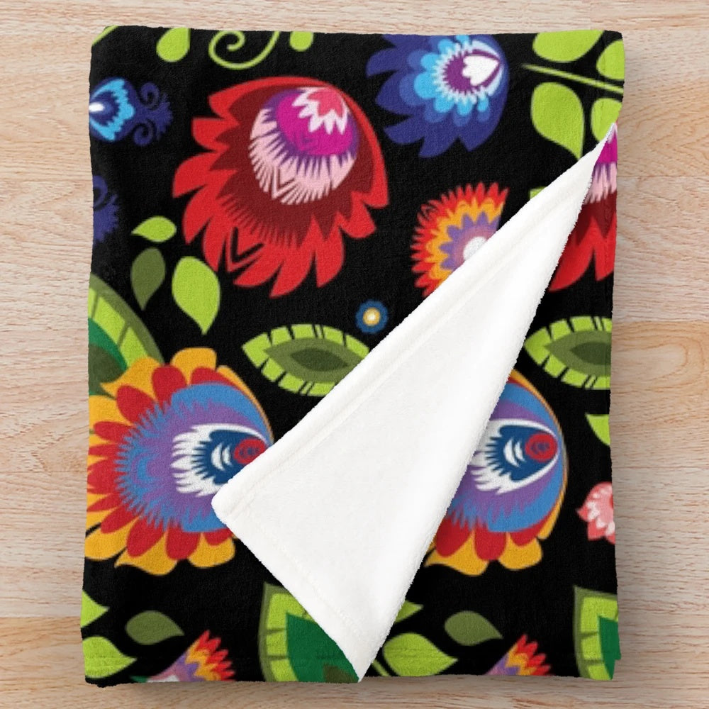 Plush blanket with intricate Polish folklore-inspired floral pattern in black and white
