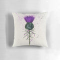 Closeup of a decorative purple and green thistle flower pattern on a plush throw pillow.