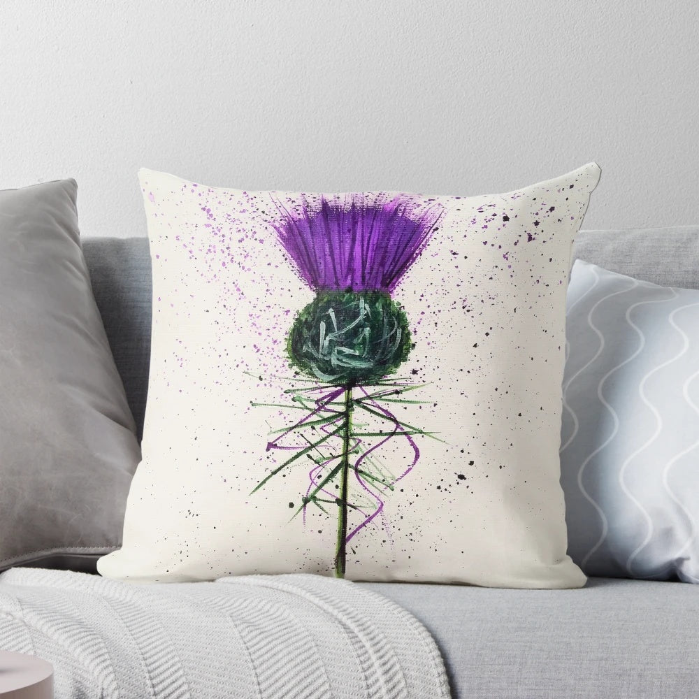 Closeup of a decorative purple and green thistle flower pattern on a plush throw pillow.