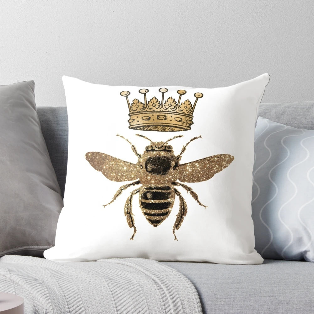 Decorative black and gold throw pillow with queen bee design