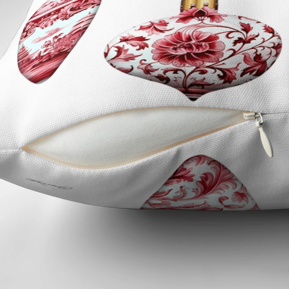 A red and gold chinoiserie-style Christmas ornament pillow with pine branches and berries
