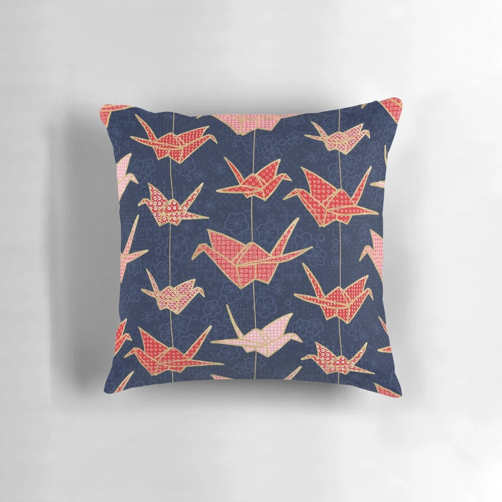 Vibrant red origami crane design on a navy blue pillow, creating a stunning Japanese-inspired accent piece.