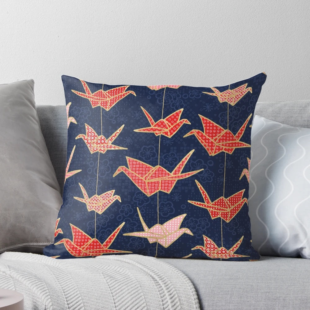 Vibrant red origami crane design on a navy blue pillow, creating a stunning Japanese-inspired accent piece.