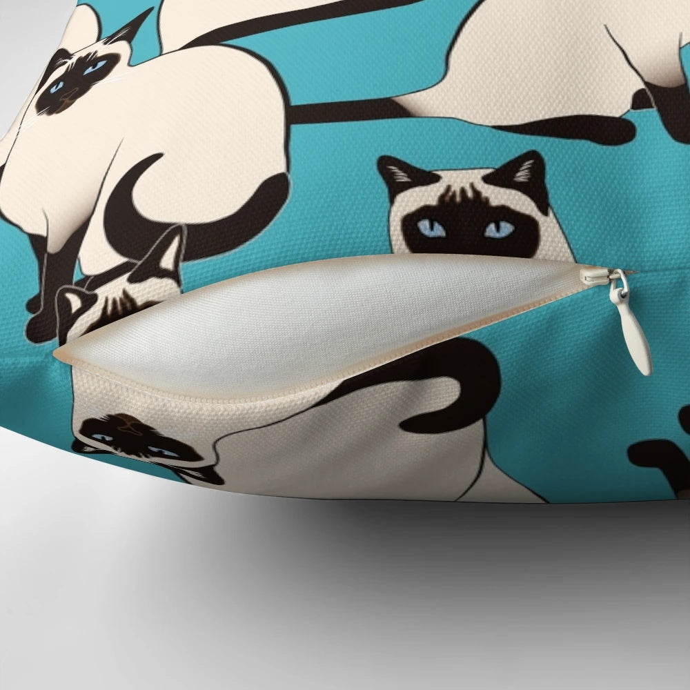 Decorative pillow featuring an elegant pattern of Siamese cats with blue eyes on a turquoise background