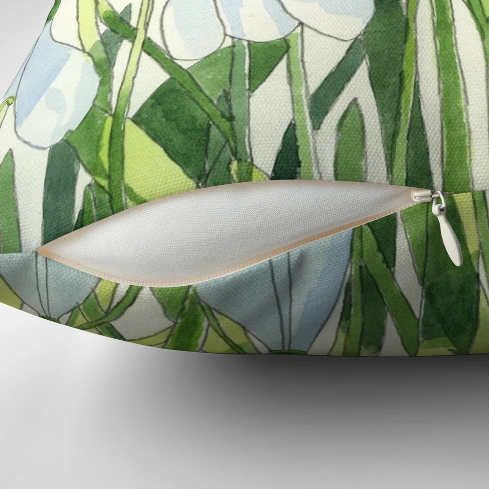 Soft, white snowdrops watercolor painting on a decorative throw pillow