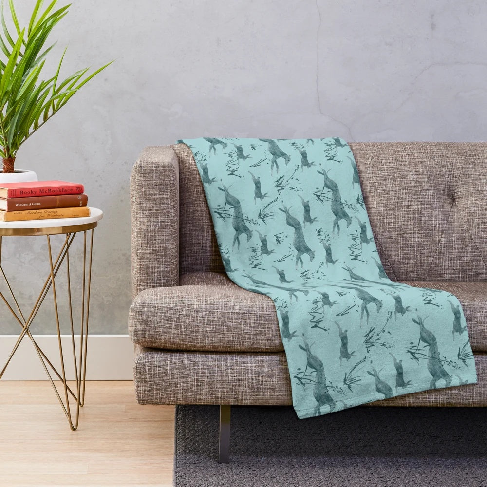 Turquoise plush blanket featuring a greyhound and hare