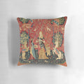 A beautiful black floral throw pillow featuring a mythological unicorn in a medieval garden setting.